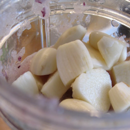Jetzt für die Mandelsauce die Zwiebeln, den Ingwer und den Knoblauch im Mixer kleinpürieren.